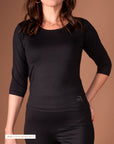 Black 3/4 sleeve activewear top from Theia Moon, sleek and soft