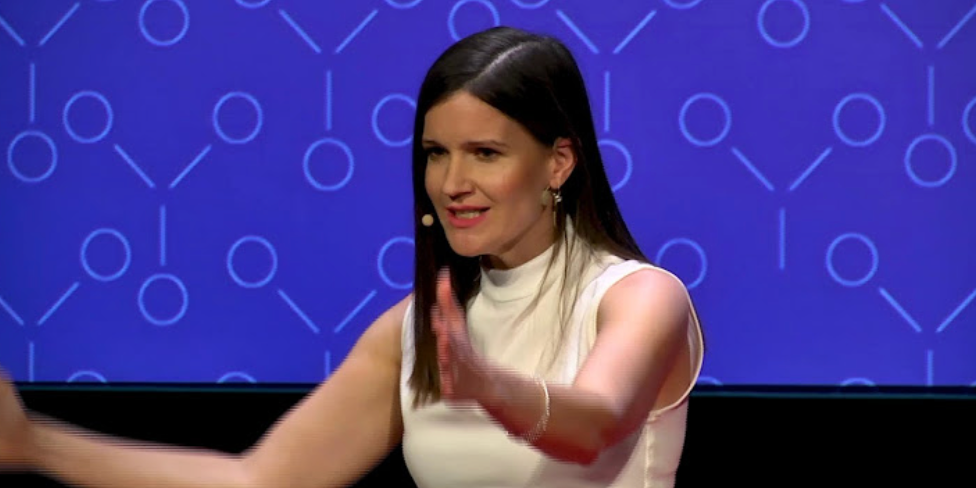 Julia Milner speaking at TEDx and international conferences, sharing research on leadership, habits and organisational wellbeing